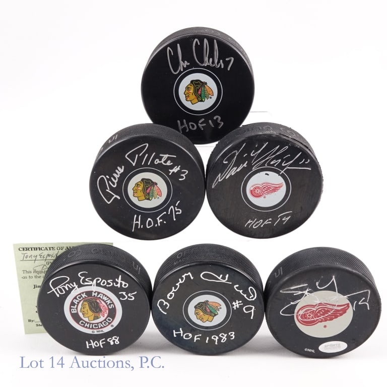 6 Signed Hockey Pucks: Six assorted hockey pucks each signed by a former player. Included are the following: Pierre Pilote signed puck inscribed "HOF 75" +++ Chris Chelios signed puck inscribed "HOF 13" with PSA sticker