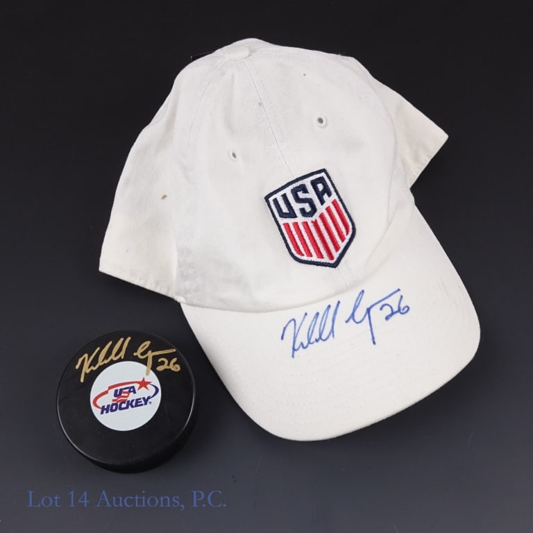 Kendall Coyne Signed Puck & Cap "AS IS": Kendall Coyne is among the most legendary woman hockey players in the world. A three time Olympian with two gold medals and one silver medal plus a career as a professional player as well as serving