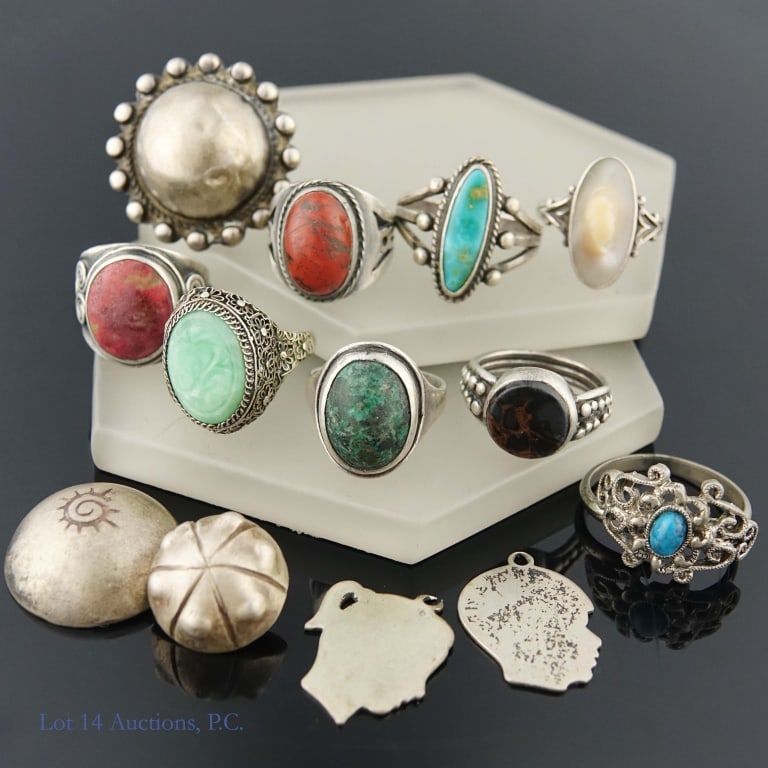 Silver Rings & Charms: 9 silver rings, one marked as sterling. The rest are unmarked, but passed an acid test for silver content. Also included in the lot are four small silver charms, one marked as sterling. Again, the