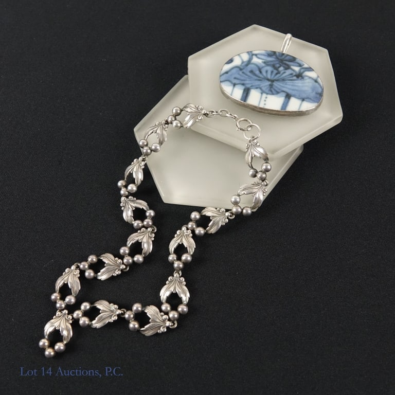 Vintage Silver Pendants & Sterling Necklace: A cut piece of Chinese porcelain set into a sterling silver frame marked 925. Also included in the lot is a necklace with leaf shaped link & chain. Both pieces weigh approximately 46.2g or 1.48 troy