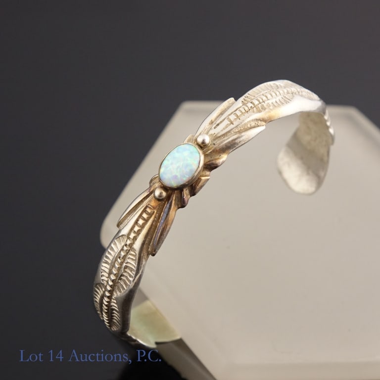 Francis L Begay Sterling Silver Cuff w/ Opal: Sterling silver cuff bracelet designed by Dine artist Francis L Begay decorated with an opal. Weighs approximately 23g or 0.73 troy oz.