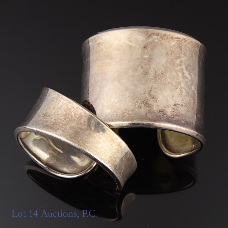 Sterling Silver Cuff Bracelets, 3ozt.t.w. (2): Two (2) sterling silver cuff bracelets, Total weight: 95g. The smaller bracelet has an outer circumference of approximately 5.75". Gap is approximately 5/8". Marked with an unknown designer's