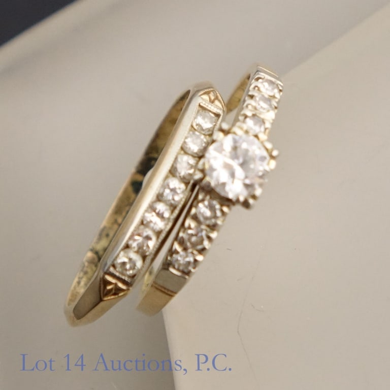 14k Gold Diamond Bridal Ring Set: Set of two size 7 rings made with 14k yellow gold, one with white gold detailing. One ring has seven 0.05ct diamonds, and the other has six 0.05ct and one 0.5ct diamond. Both rings together weigh