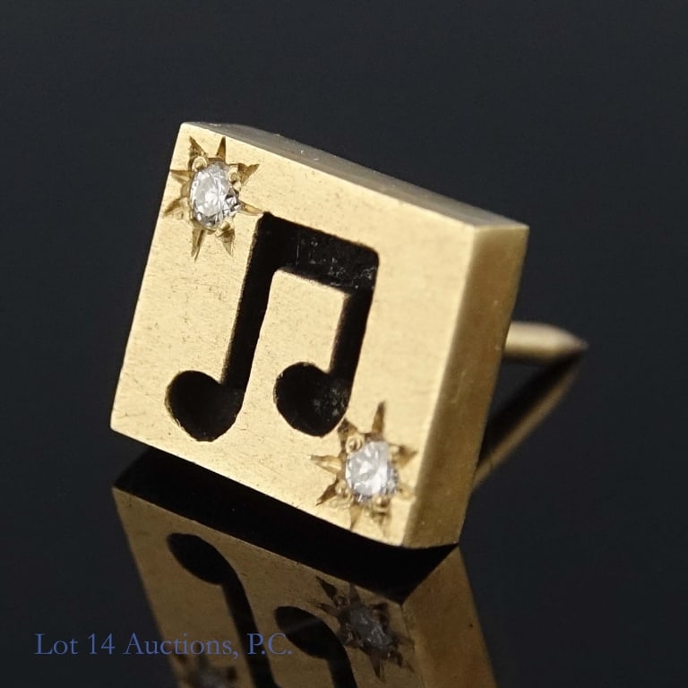 14k Yellow Gold Lapel Pin w/ Diamonds: Small lapel pin decorated with a music note and two small melee diamonds, made from 14k yellow gold. Weighs approximately 2.76g or 0.08 troy oz.
