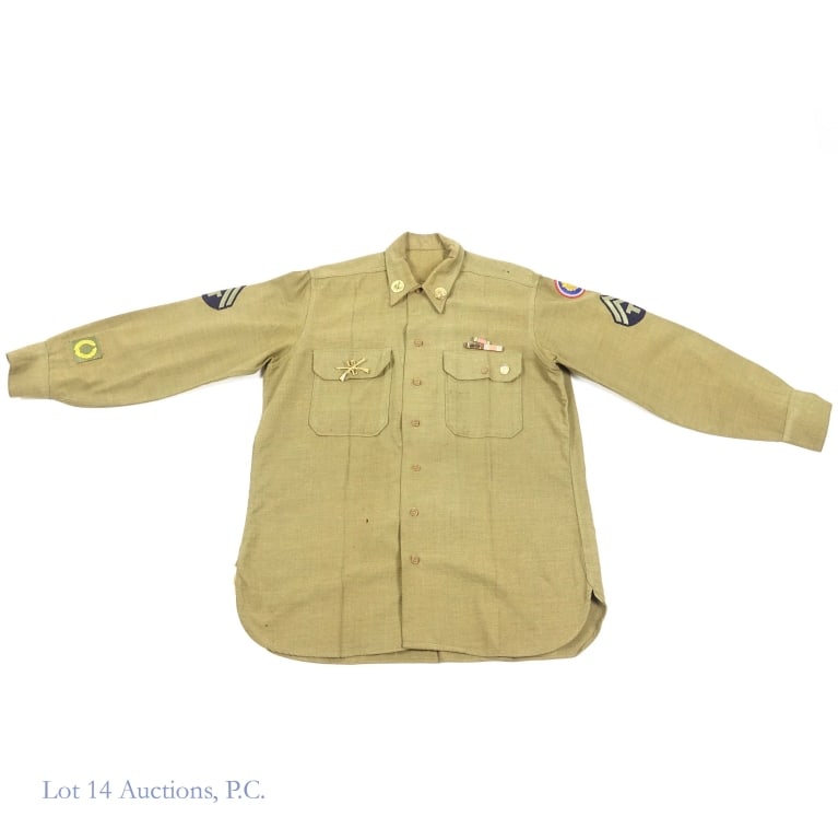 WWII Army Shirt (Tec 5, 15th Reg Comp L): World War II US army green shirt. Left & right sleeve has two chevrons and a "T" representing a Technician fifth grade (T/5 or Tec 5). At right wrist is a Meritorious Unit Award patch. Left shoulder