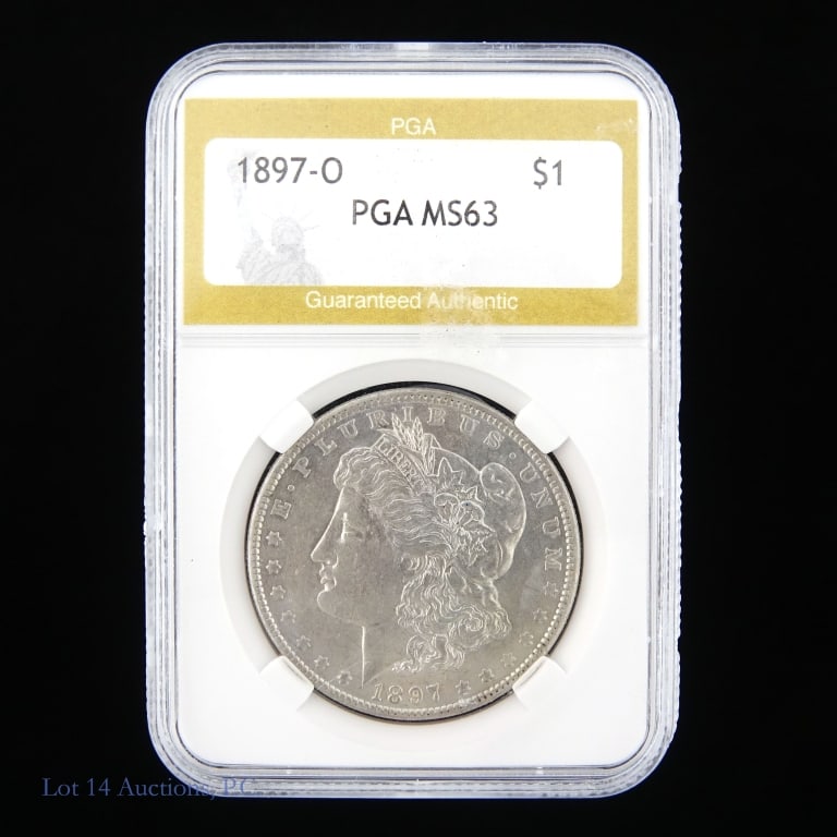 1897-O Silver Morgan Dollar: 1897-O United States silver Morgan dollar (New Orleans Mint). PGA slabbed MS63. Metal is 90% silver. Mintage 4 million. Silver content confirmed on Lot 14 Auctions electronic metal verifier. Per Greys