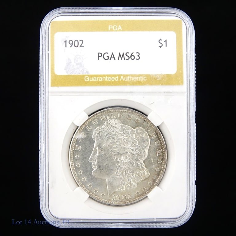 1902 (P) Silver Morgan Dollar: 1902 (P) United States silver Morgan dollar (Philadelphia Mint). Metal is 90% silver. PGA slabbed MS63. Mintage 8 million. Silver content confirmed on Lot 14 Auctions electronic metal verifier.
