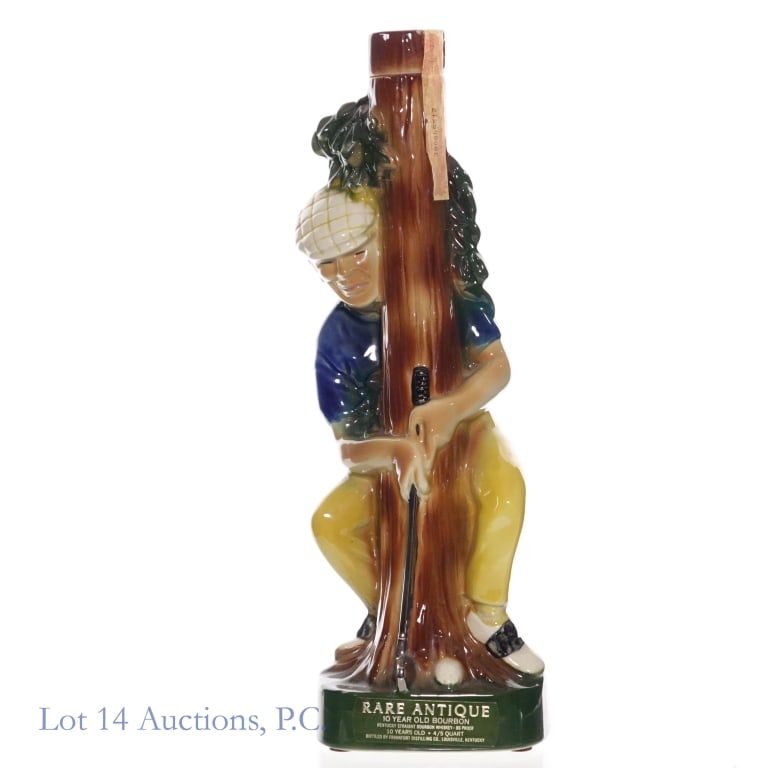 1971 Rare Antique 10 Year Bourbon Golfer Decanter: 1971 Rare Antique 10 Year Old Bourbon. 86 Proof, 4/5 Quart. Golfer ceramic decanter. Tax strip shows some wear but is fully intact.