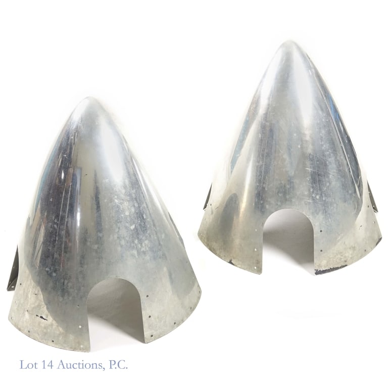 4-Prop Airplane Propeller Hub Cover (2): Two (2) hub covers for a 4-prop airplane propeller. Appear to be aluminum. Approximately 21" long (base-to-tip). Prop openings are arch shaped with maximum dimensions of approximately 5" x 6-5/8".