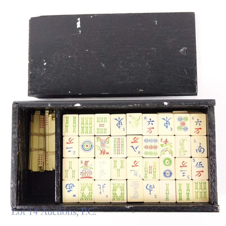 1920s Bone And Bamboo Mahjong Set: 1920s bone and bamboo Mahjong set. Set Includes 144 bone and bamboo tiles and bone betting sticks housed in a wooden carrying case. Scoring card attached to the underside of the sliding case cover.