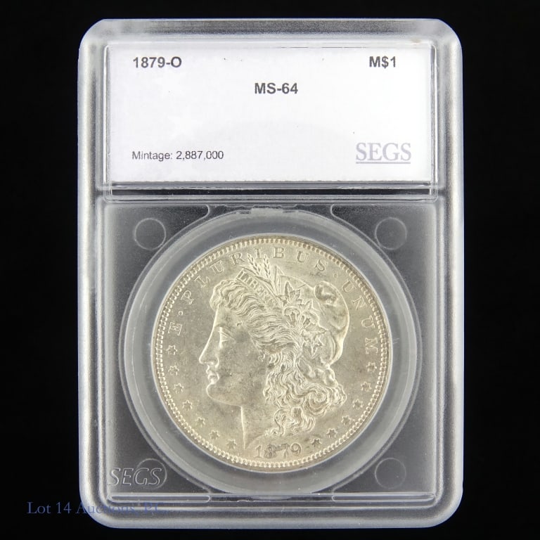 1879-O Silver Morgan Dollar (SEGS): 1879-O United States silver Morgan dollar (New Orleans Mint). SEGS slabbed at MS64. Metal is 90% silver. Mintage 2,887,000. Silver content confirmed on Lot 14 Auctions electronic metal verifier. Greys