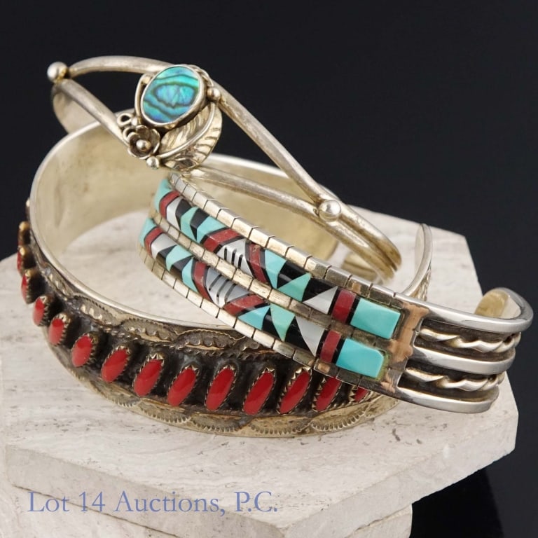 Sterling Silver Cuff Bracelets (Some Zuni): Three cuff bracelets made with sterling silver. One is unsigned. One is embedded with coral, resembles a Zuni style, and is signed "JR". One is decorated with turquoise and coral and is signed