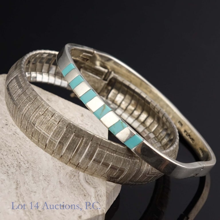 Two Sterling Silver Bracelets: Two bracelets, both marked as 925 sterling silver. One of them is decorated with six small pieces of turquoise. Both bracelets together weigh approximately 1.65 troy oz.