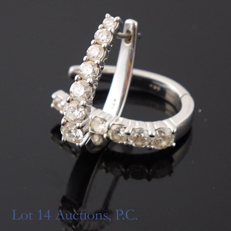 14k White Gold Hoop Earrings w/ Precious Stones: Oblong hoop earrings made with 14k white gold, decorated with 7 precious stones of various styles each. The stones electronically tested as topaz. Total weight of both earrings together is