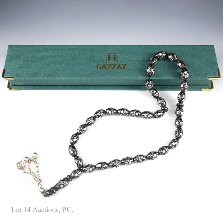Gazzaz Black Coral Prayer Bead Necklace: Gazzaz Black Coral Prayer Bead Necklace. A Gazzaz black coral prayer bead necklace with silver inlays. Necklace length - 18". Marker / tassel length - 4". Item in original packaging. Little to no