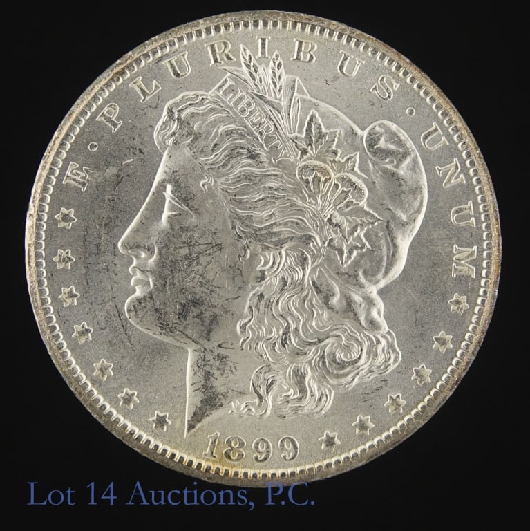 1899-O US Silver Morgan $1 (*BU w/ Rev Die Cracks): 1899-O United States silver Morgan dollar (New Orleans Mint). *Per consigner, from an original bag which explains cheek abrasions in spite of abundant original luster in BU condition note numerous die