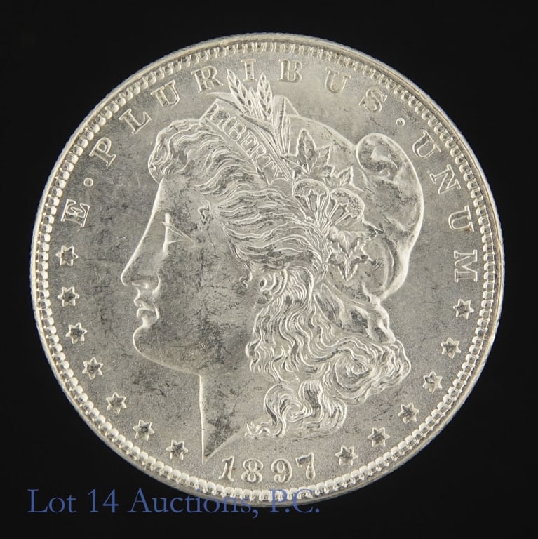 1897 (P) US Silver Morgan Dollar (BU): 1897 (P) United States silver Morgan dollar (Philadelphia Mint). Per consigner, in BU condition. Metal is 90% silver (ASW 0.7734 ozt). Mintage 2,822,000. Greysheet wholesale price guide value at MS 63