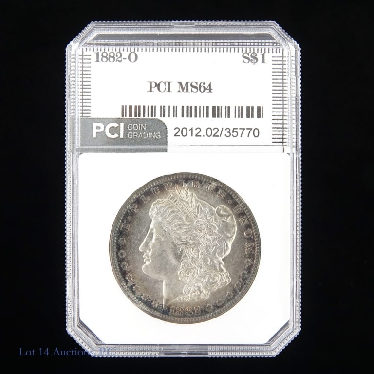 1882-O US Silver Morgan Dollar (PCI): 1882-O United States silver Morgan dollar (New Orleans Mint). PCI slabbed MS64 with slight obverse toning around edge. Metal is 90% silver. Mintage 6,090,000. Silver content confirmed on Lot 14 Auctio