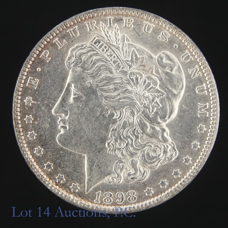 1898 (P) US Silver Morgan Dollar (*BU): 1898 (P) United States silver Morgan dollar (Philadelphia Mint). *Per consigner, in BU condition. Metal is 90% silver (ASW 0.7734 ozt). Mintage is 5,884,000. Greysheet wholesale price guide value at M