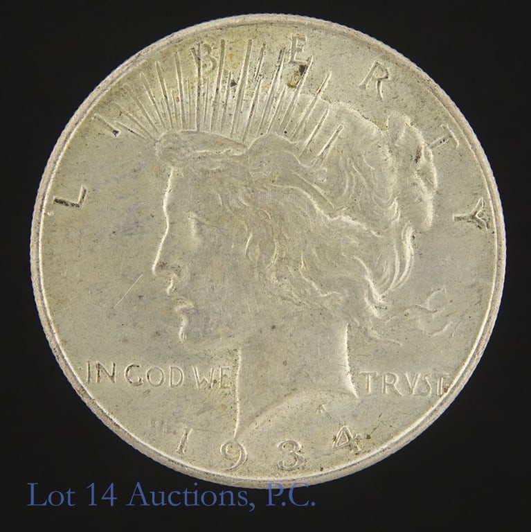 1934-D US Silver Peace Dollar: 1934-D United States silver peace dollar (Denver Mint). Per consigner, has halo luster on reverse and tough to find in higher grades especially in AU condition. Greysheet also reports "one of the far 