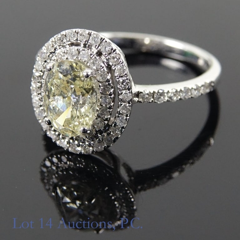 14k White Gold Yellow Diamond Ring: Size 6 ring made with 14k white gold, decorated with diamonds (1.10 ct center yellow diamond, 0.38 cttw melee diamonds surrounding it). Total weight of ring is approximately 2.8g. Identification and a