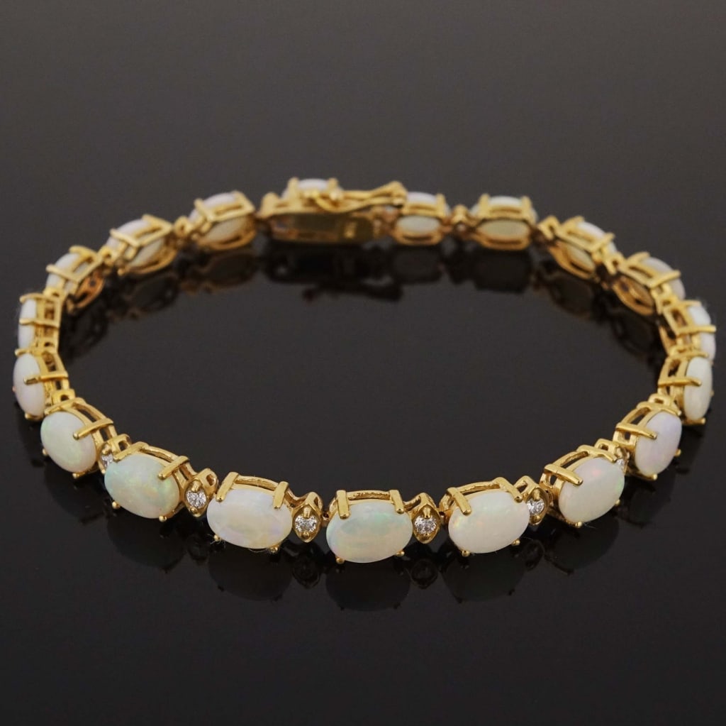 14k Yellow Gold Opal & Diamond Bracelet: Clasp bracelet made with 14k yellow gold, decorated with alternating opals and diamonds (19 opals weighing 8.62 cttw, 19 diamonds weighing 0.82 cttw). Total weight of bracelet is approximately 9.7g.