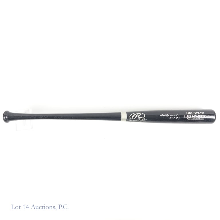 Luis Aparicio Signed Bat With COA: Full size Rawlings Adirondack Pro bat signed across the barrell by HOF member Luis Aparicio. Aparicio signed with a silver paint pen and also added the inscription "HOF 84". The signature displays