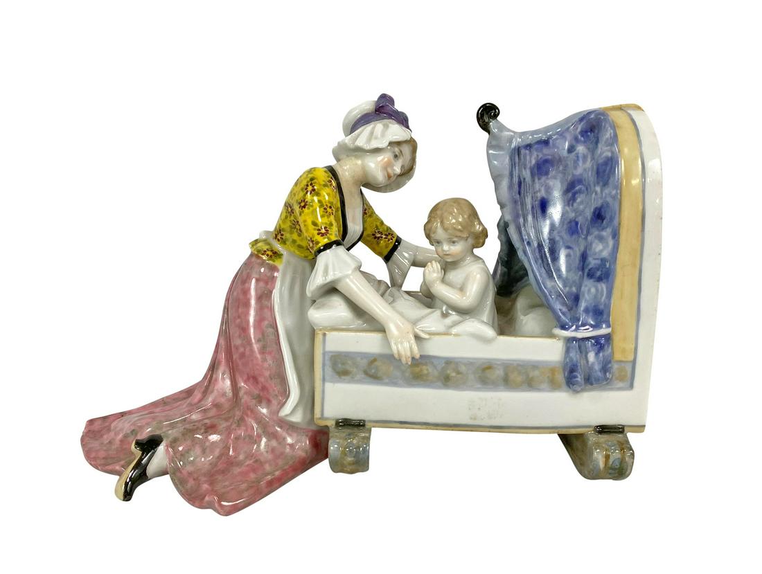 Karl ENS German Porcelain Mother & Child Figurine: Mid century, Karl ENS hand painted polychrome porcelain figure of a mother and child in crib. Circa: 1940s-1950s. Blue ENS Germany mark under glaze to base. Measures: 9-1/2" L x 4" W x 6" H. Total Wei