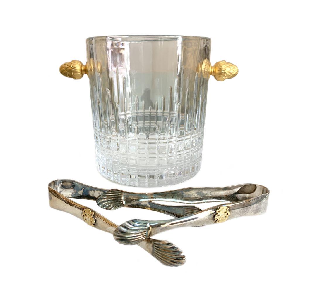 Faberge Crystal Champagne Bucket w/ Silver Tongs: Faberge acorn handled crystal champagne ice bucket accompanied by Russian Imperial silver plate tongs featuring a seashell motif & gilded royal double eagle crest to center. Signed to base. Ice Bucket