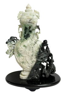 Chinese Black & White Jade Vase w/ Rings: Chinese hand carved black and white jade bottle-form covered vessel with rings atop a wooden base. Measures: 6-1/8" L x 2-5/8" W x 9-1/4" H. Base: 7" L x 4-1/2" W x 1" H. Provenance: Private