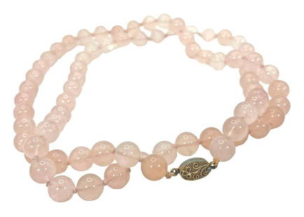 Vintage Chinese Rose Quartz Silver Beaded Necklace: A vintage Chinese pink rose quartz single strand beaded necklace. Crafted with vermeil sterling silver filigree open box clasp. Marked "Silver". Each bead is hand knotted in between and measure