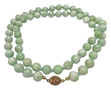 Vintage Chinese Jade Silver Clasp Beaded Necklace: A vintage Chinese green and white jade single strand beaded necklace. Crafted with vermeil sterling silver filigree open box clasp. Marked "Silver". Each bead is hand knotted in between and measure