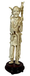 Antique Chinese Hand Carved Medicine Man Figure: Antique Chinese hand carved bone figure of a hooded a witch doctor/medicine man carrying a walking stick and cross body container bag. Measures: 11-1/2" Tall x 3-1/4" Wide. Bone: 10" H x 2-1/4" W.