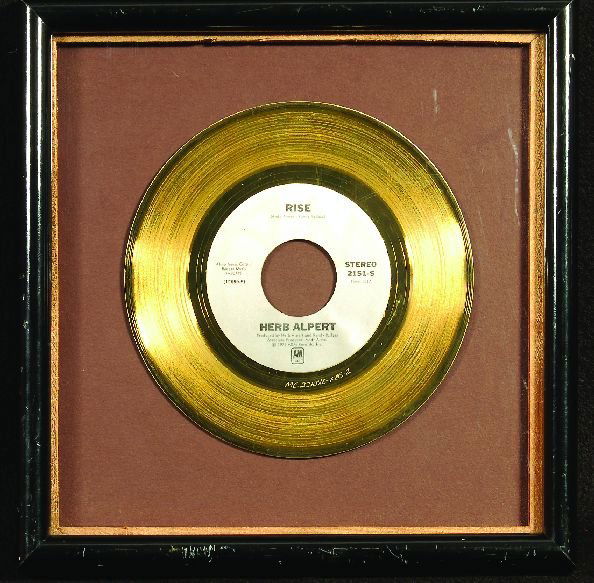 76* Herb Alpert "Rise" gold 45 display: A presentation gold disc for the Grammy award winning. Float mounted, framed and glazed. Measures 11 x 11 inch. SOLD WITHOUT RESERVE