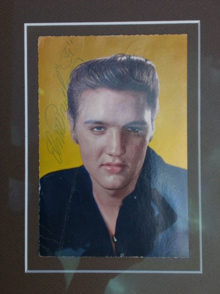 Elvis Signed Postcard: Elvis Signed Postcard Elvis Presley Signed Postcard A fantastic early picture postcard depicting the young Elvis signed and dated signed in blue ink. Mounted framed and glazed. Estimate GBP300-400