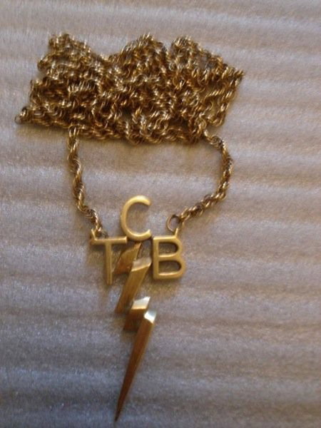 Elvis Presley Original TCB Given to GI Blues Direc: Elvis Presley's TCB 14 kt Gold necklace given to Norman Taurog. Elvis was known to be generous to those around him and one of the ways that he would show his generosity would be to award his friends w