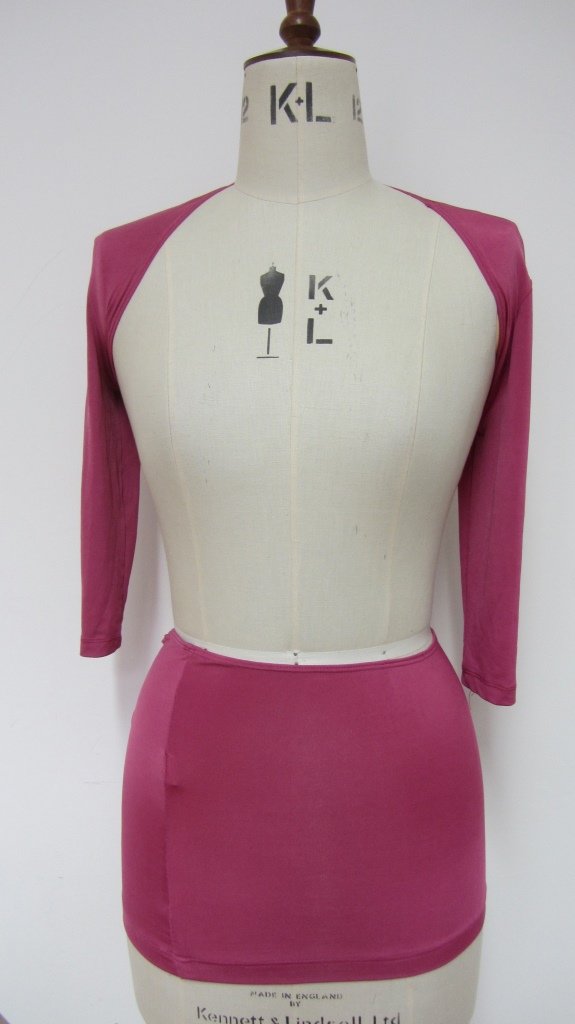 Britney Spears. A stage worn two piece: Britney Spears. A stage worn two piece top and skirt in Cerise/pink stretch lycra. The top is signed Britney in blue pen.