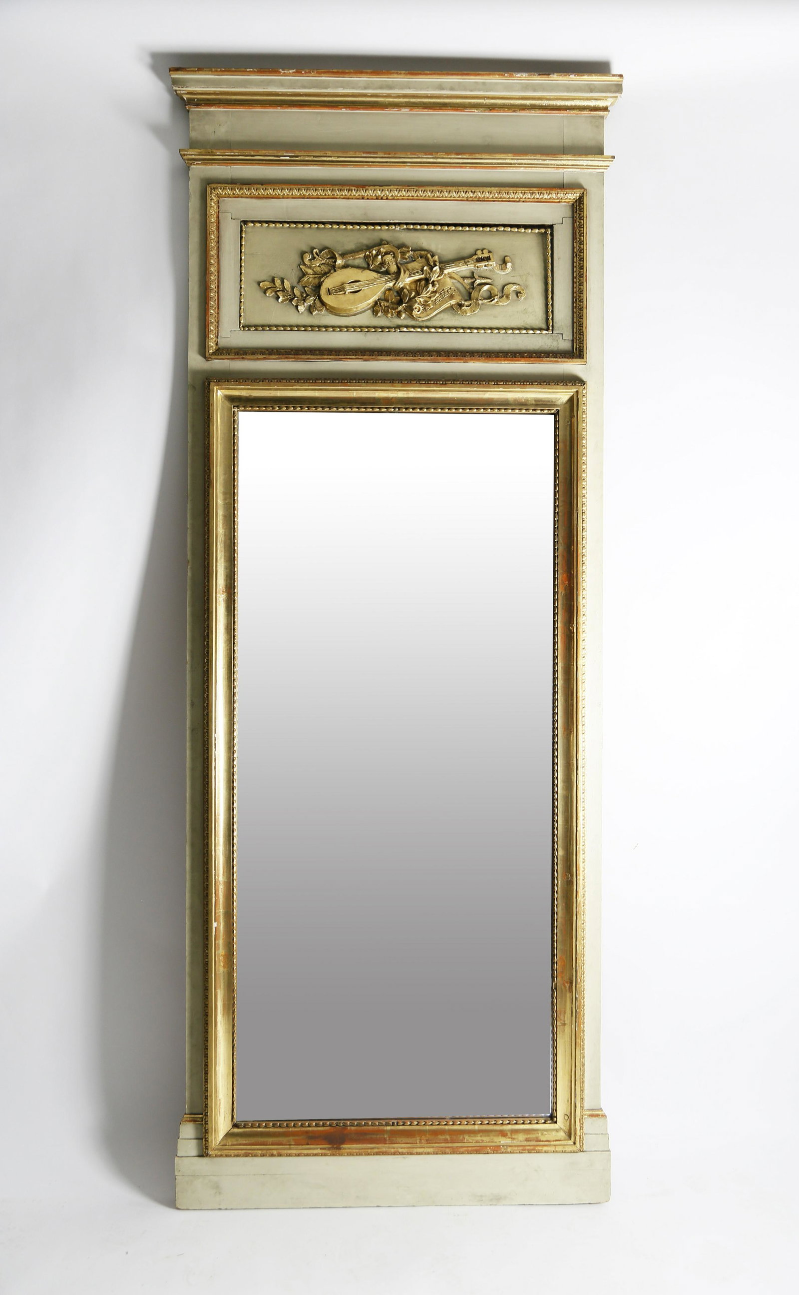 French Trumeau Mirror, circa 1870: French Trumeau Mirror, circa 1870, painted an olive green, gilt trim with a carved inset panel depicting a lute, sheet music and leaves. 105 in. x 41 in. Provenance: Estate of Linda Loring, 6 Louisbur