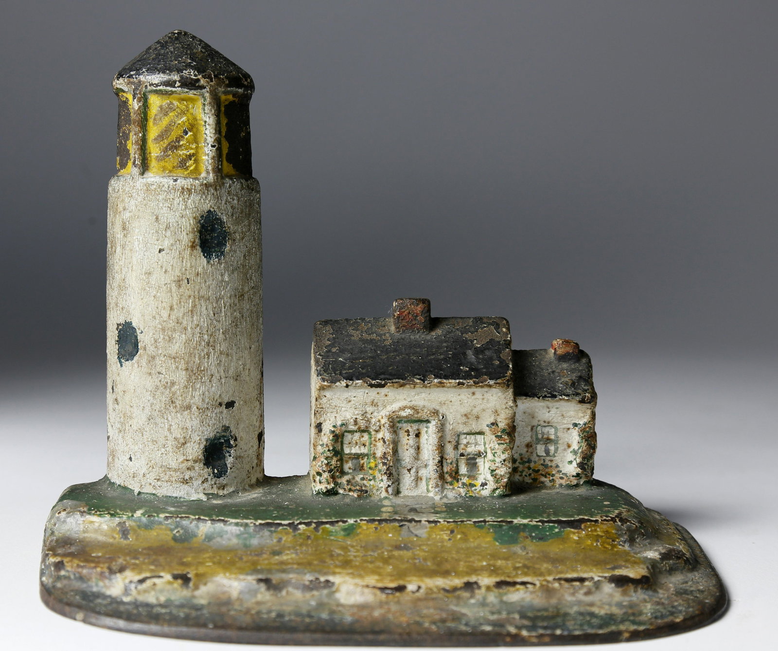 Scarce Antique Cast Iron Lighthouse Doorstop: Scarce Antique Cast Iron Lighthouse Doorstop, original paint decoration. Height 6 ¼ in. Width 7 ¾ in.
