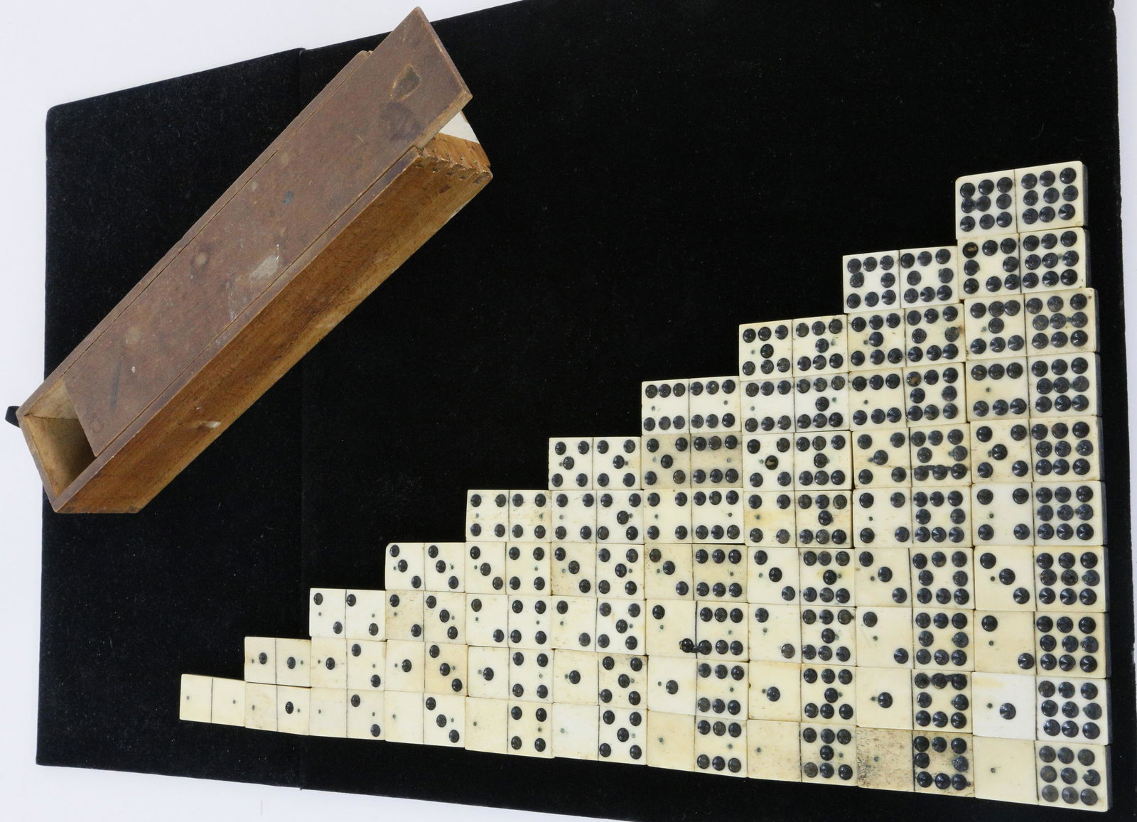 Complete Set of Sailor Made Bone and Ebony Double Nine: Complete Set of Sailor Made Bone and Ebony Double Nine Dominoes, 19th Century, 55 tiles, each double pinned with brass tacks, in fitted pine dovetailed slide top box. Box Length 10 ¾ in.