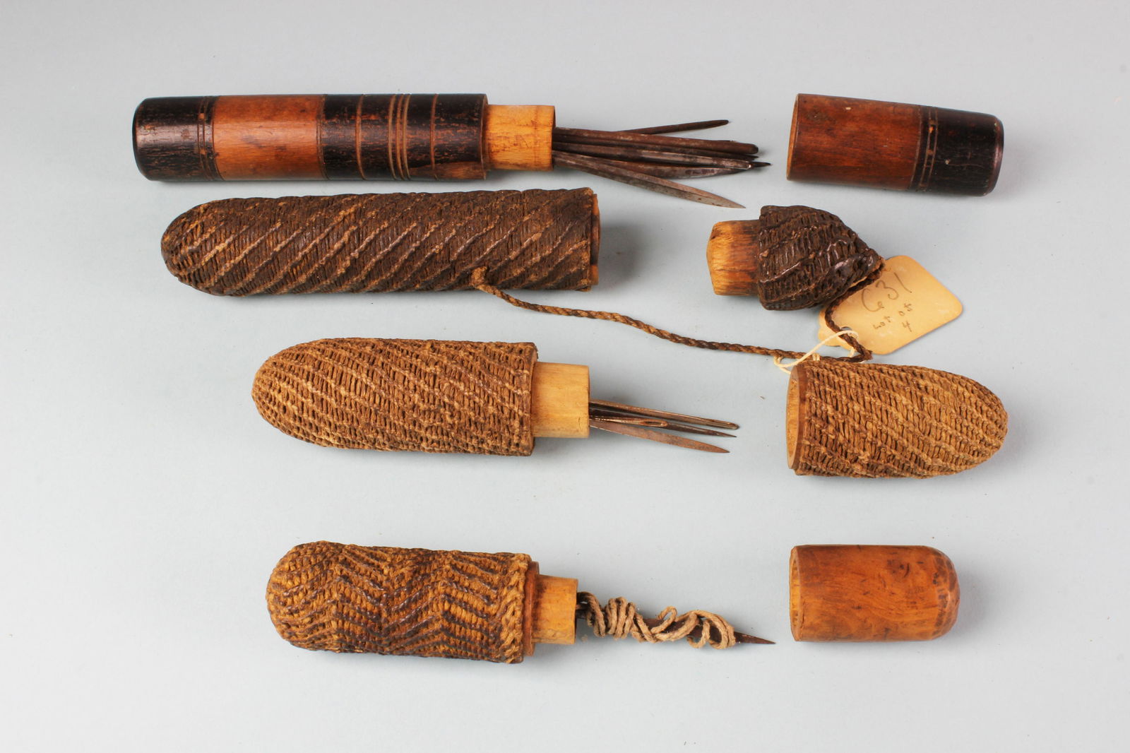 Four Needle Cases, circa 1840-1860: Four Needle Cases, circa 1840-1860, three of fine macramé and the fourth of turned and stained wood. 4 ½ in. to 7 ½ in.