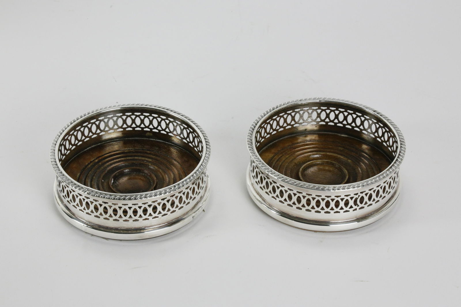 Two Sheffield Silver Plated Wine Coasters, 19th Century: Two Sheffield Silver Plated Wine Coasters, 19th Century, turned wooden base, gadrooned edge and pierced decoration. Height 1 ¾ in. Diameter 4 ½ in.