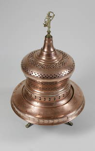 Antique Copper Turkish Brazier: Antique Copper Turkish Brazier, brass figural finial, standing on three brass paw feet, pierced body decoration, in two parts. Height 29 in. Diameter 19 in. Dimensions Height 29 in. Diameter 19