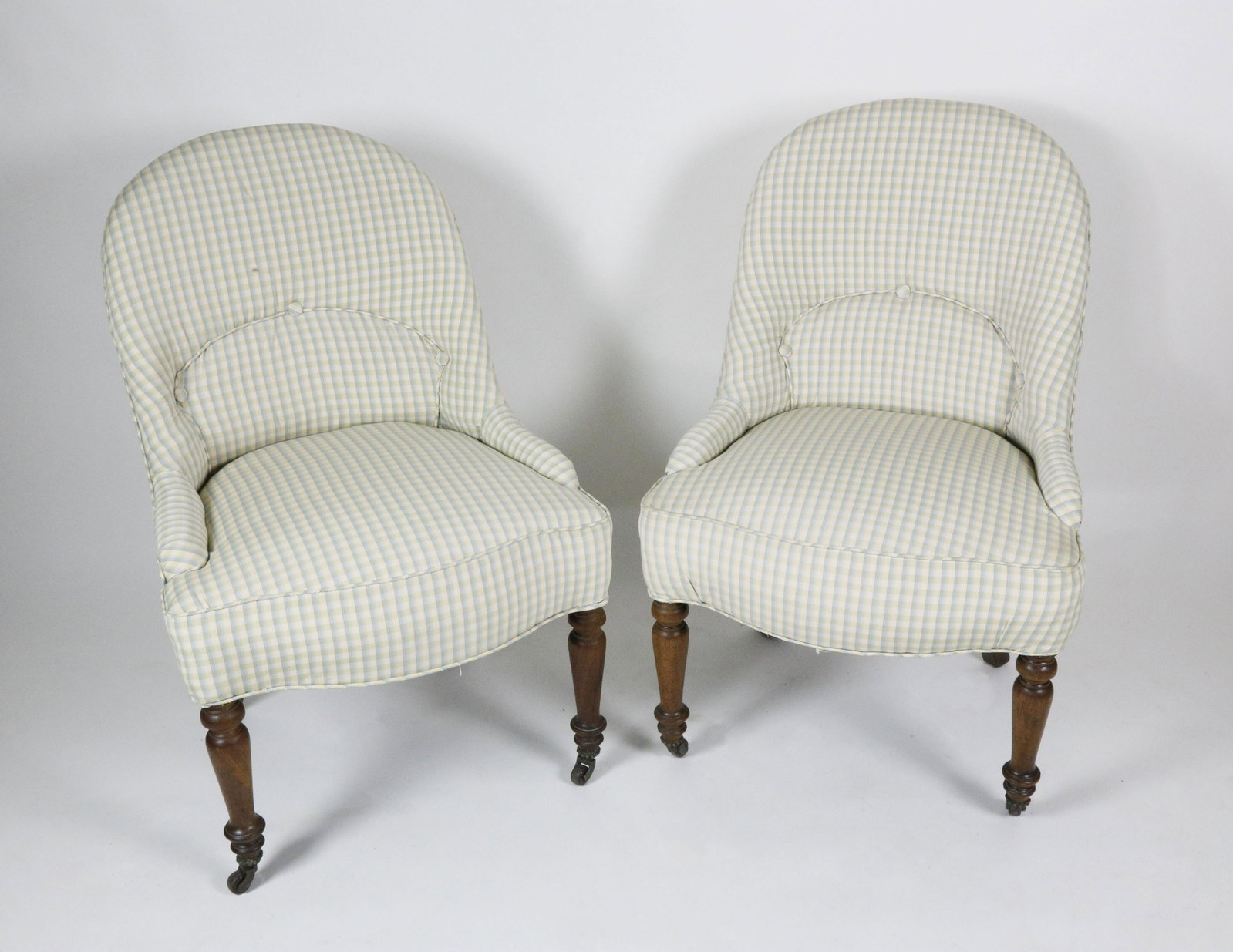 Pair of Gingham Upholstered Slipper Chairs: Pair of Gingham Upholstered Slipper Chairs, on turned mahogany legs ending in brass casters Height 33 in. Width 22 in. Depth 27 in. Dimensions Height 33 in. Width 22 in. Depth 27 in. Ori