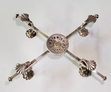 19th Century Silver Plated Trivet: 19th Century Silver Plated Trivet, with scallop shell knees on lily pad feet, adjustable pads with compacting center. Height 3 in. Width Closed 12 in. Dimensions Height 3 in. Width Closed 12 in.