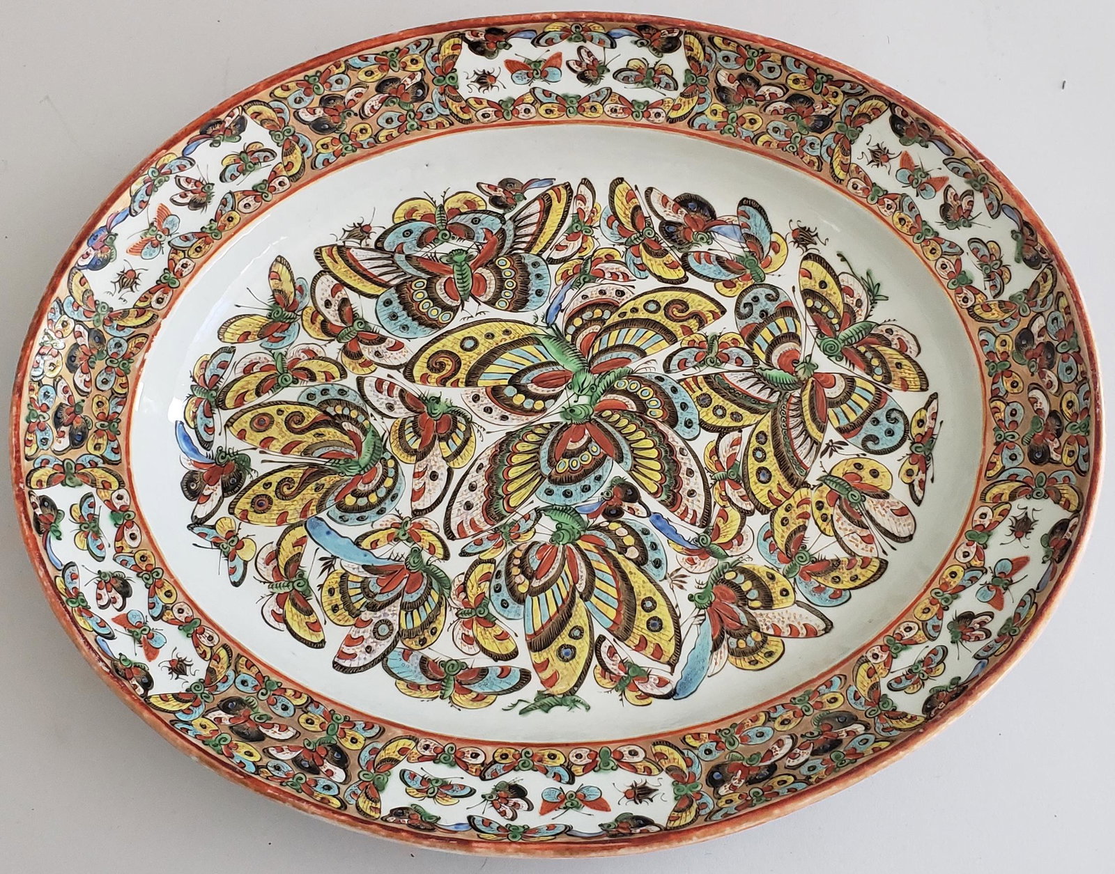 Antique Chinese Thousand Butterfly Pattern Serving: Antique Chinese Thousand Butterfly Pattern Serving Platter, stamped on verso, "Made in China", repair to the underside of one of the carrying positions as seen in photos. 16 in. x 13 in. Dimensions 1