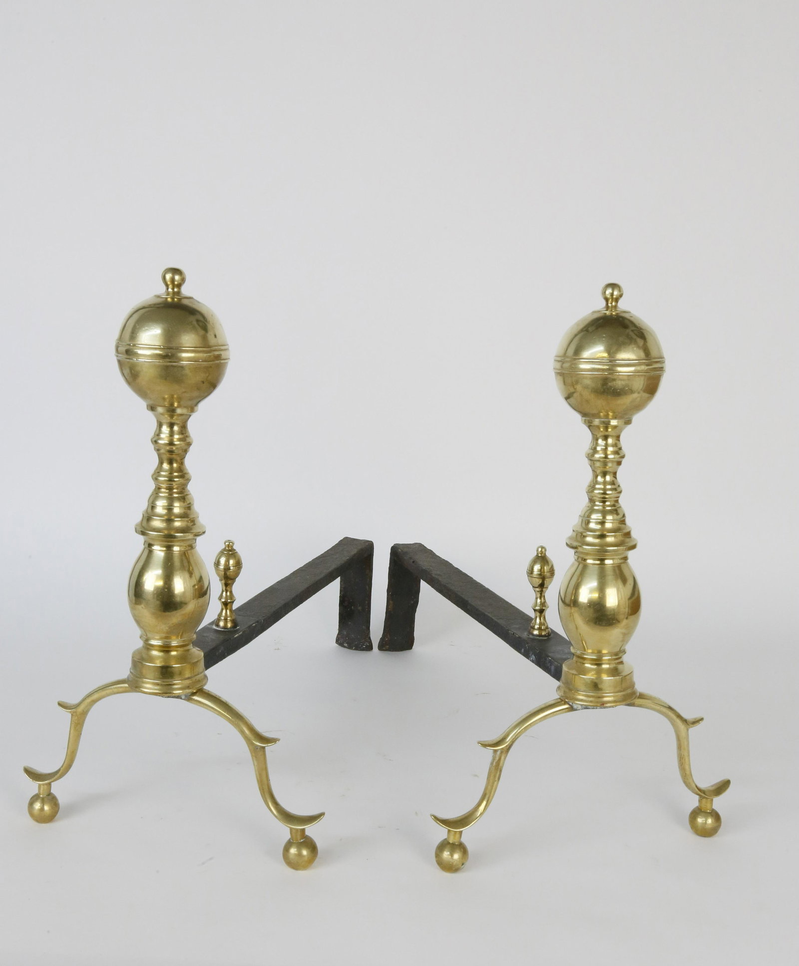 Pair of Brass Boston Ball Top Andirons, 19th Century: Pair of Brass Boston Ball Top Andirons, 19th Century, nipple finials, turned standard, on arched spurred legs ending in balls, and matching log stops Height 16.5 in. Depth 20 in. Dimensions: Hei