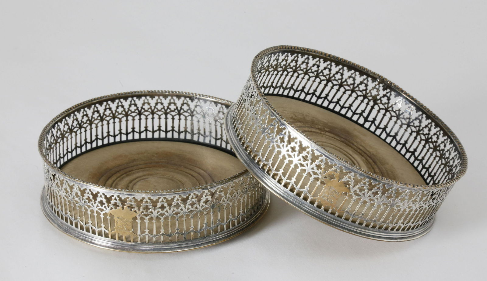 Pair of English Georgian Silver Plate and Wood Wine: Pair of English Georgian Silver Plate and Wood Wine Coasters, early 19th Century, engraved with bird and rabbit panel within a fine pierced and beaded gallery, turned and scribed wood base Height 1.5