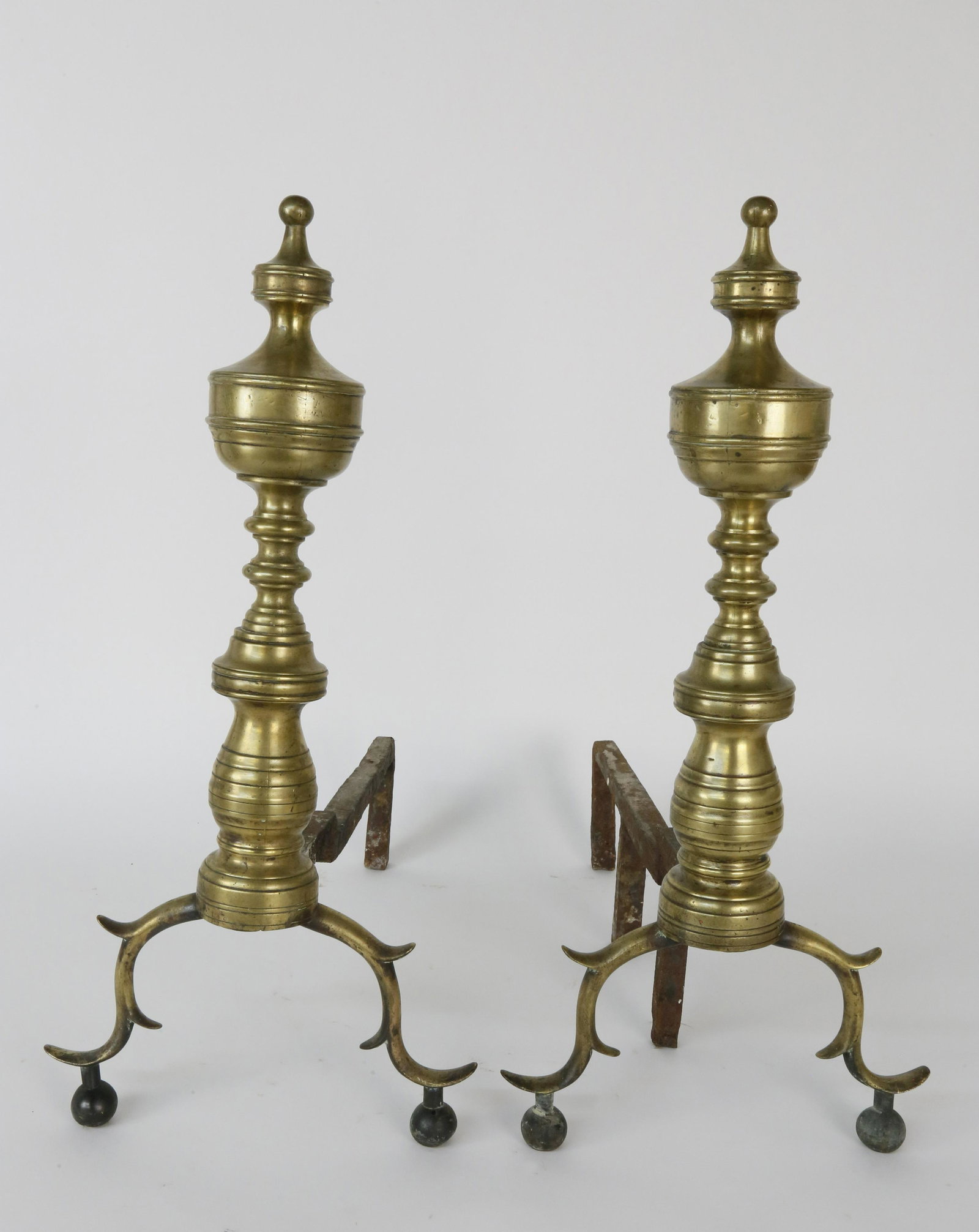 Pair of 19th Century Brass Urn and Finial Andirons: Pair of 19th Century Brass Urn and Finial Andirons, on triple spurred arched legs ending in ball feet. Height 19.5 in. Depth 18 in.