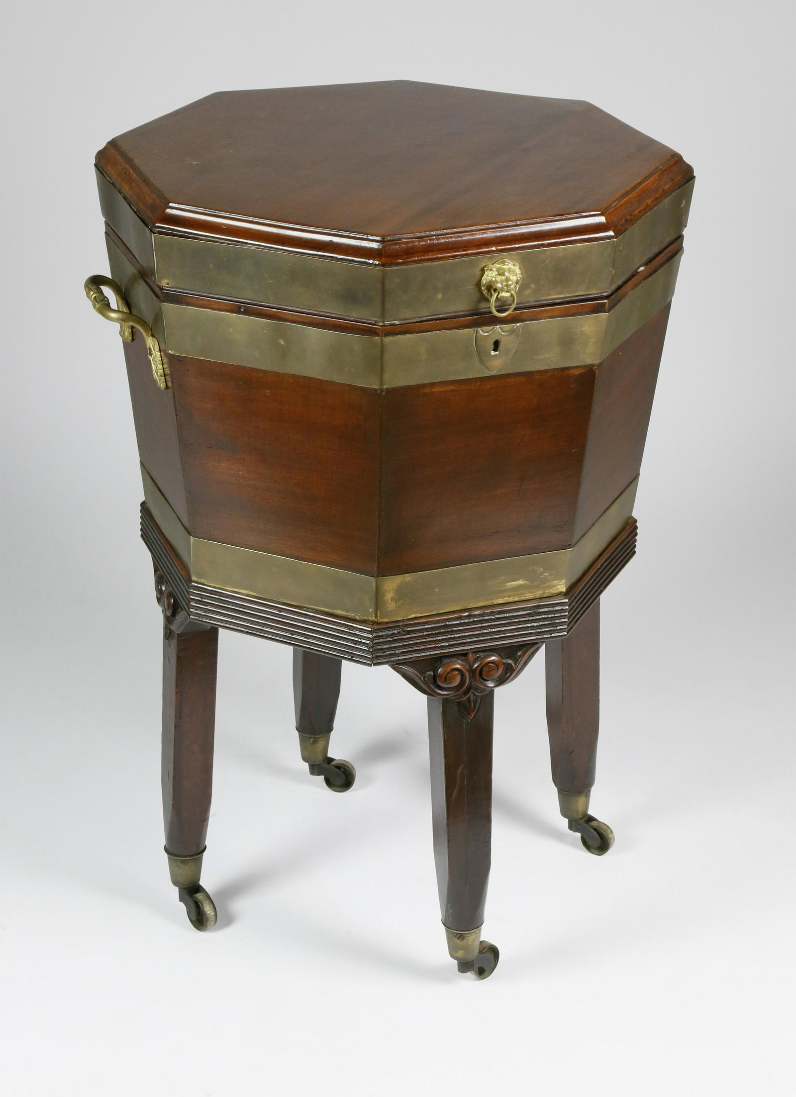 George III Brass-Mounted Mahogany Cellarette: George III Brass-Mounted Mahogany Cellarette, circa 1800, of tapered octagonal form with hinged cover opening to zinc-lined interior with drain and loose bottle holder; attached reed molded frame on l